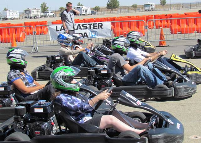 Members of the media test drive the go-karts at the AV Fairgrounds Tuesday.