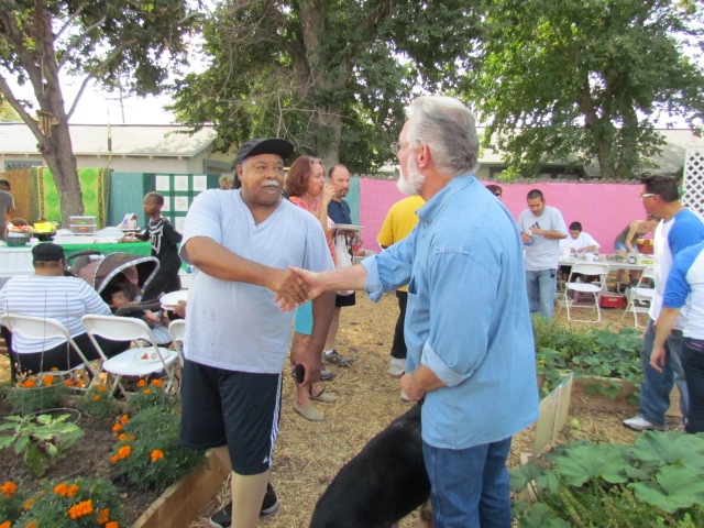 Wyatt Coleman of Lancaster shakes hands with Mayor R. Rex Parris at the Elm Avenue Community Garden