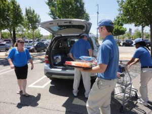 Helpful Guys in Blue carry groceries and load cars for shoppers around Sam’s Club in Lancaster.