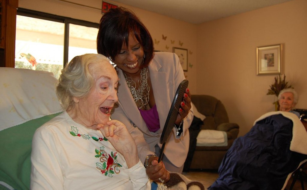 Florence Fowler checks out her beauty makeover, while Brandy Wheeler of ProCare Hospice holds the mirror.