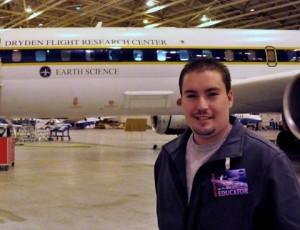 Palmdale teacher Brian Tanner stands in front of a DC-8 aircraft.