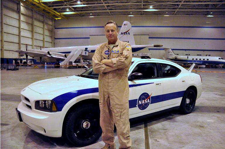 NASA pilot Stuart Broce poses in front of a ER-2 Chase Vehicle.