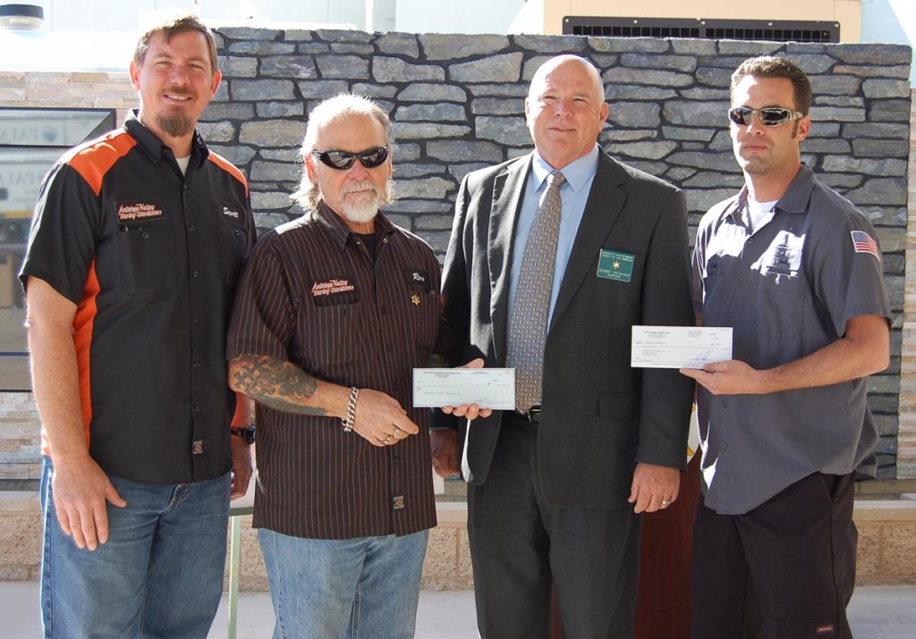 (L to R) Scott Kellerman and Ron Emard of Antelope Valley Harley Davidson, Palmdale Station Captain Bobby Denham, and Eric Mongack of Sixth Street Towing. Antelope Valley Harley Davidson and Sixth Street Towing donated a total of $10,000 to the Palmdale Station Memorial on Wednesday.