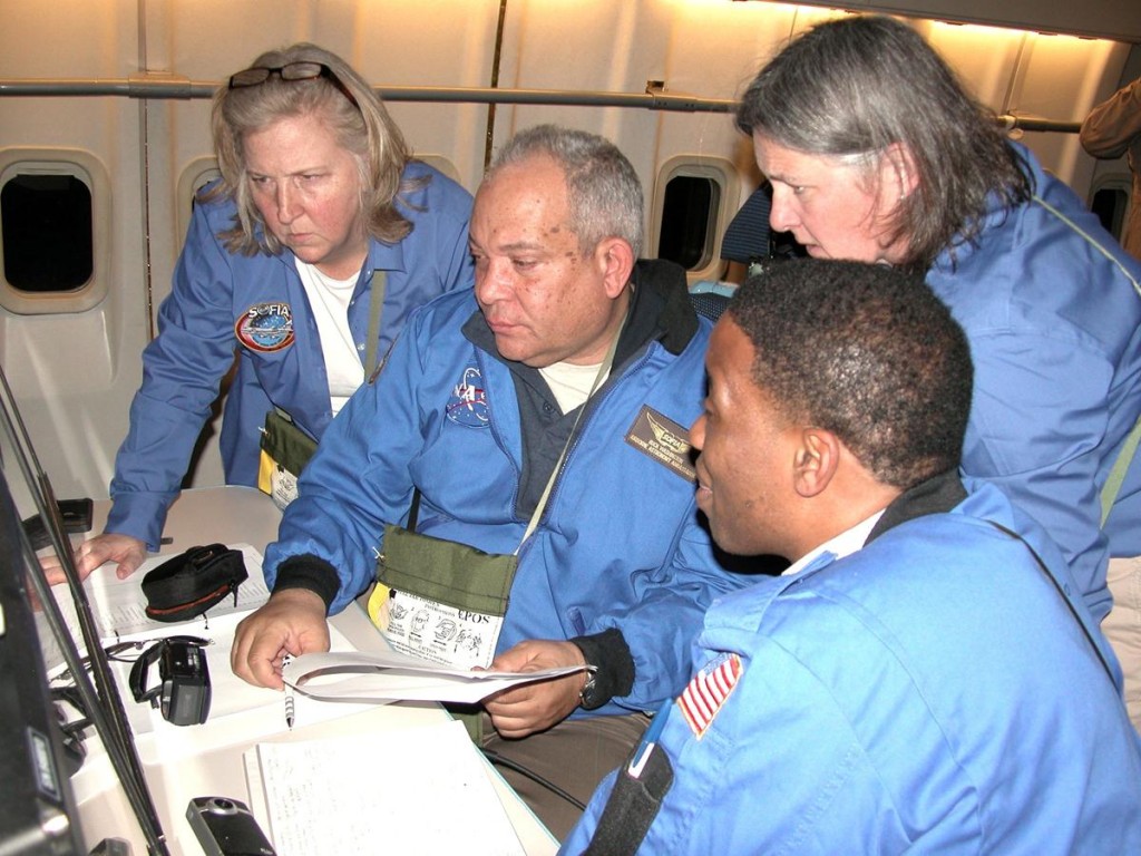 Airborne Astronomy Ambassadors (from left) Constance Gartner, Vince Washington, Ira Hardin and Chelen Johnson at the educators’ work station aboard the SOFIA observatory during a flight on the night of Feb. 12-13, 2013. (NASA / Pam Harman)