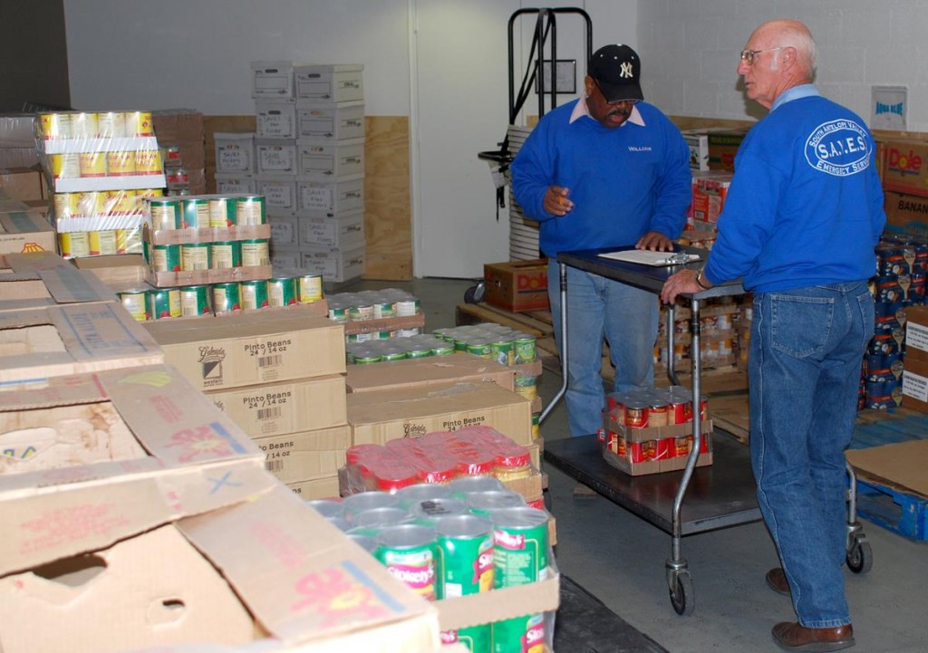 SAVES volunteers help stock donated food items. In 2012, SAVES provided over 70,000 meals for families.